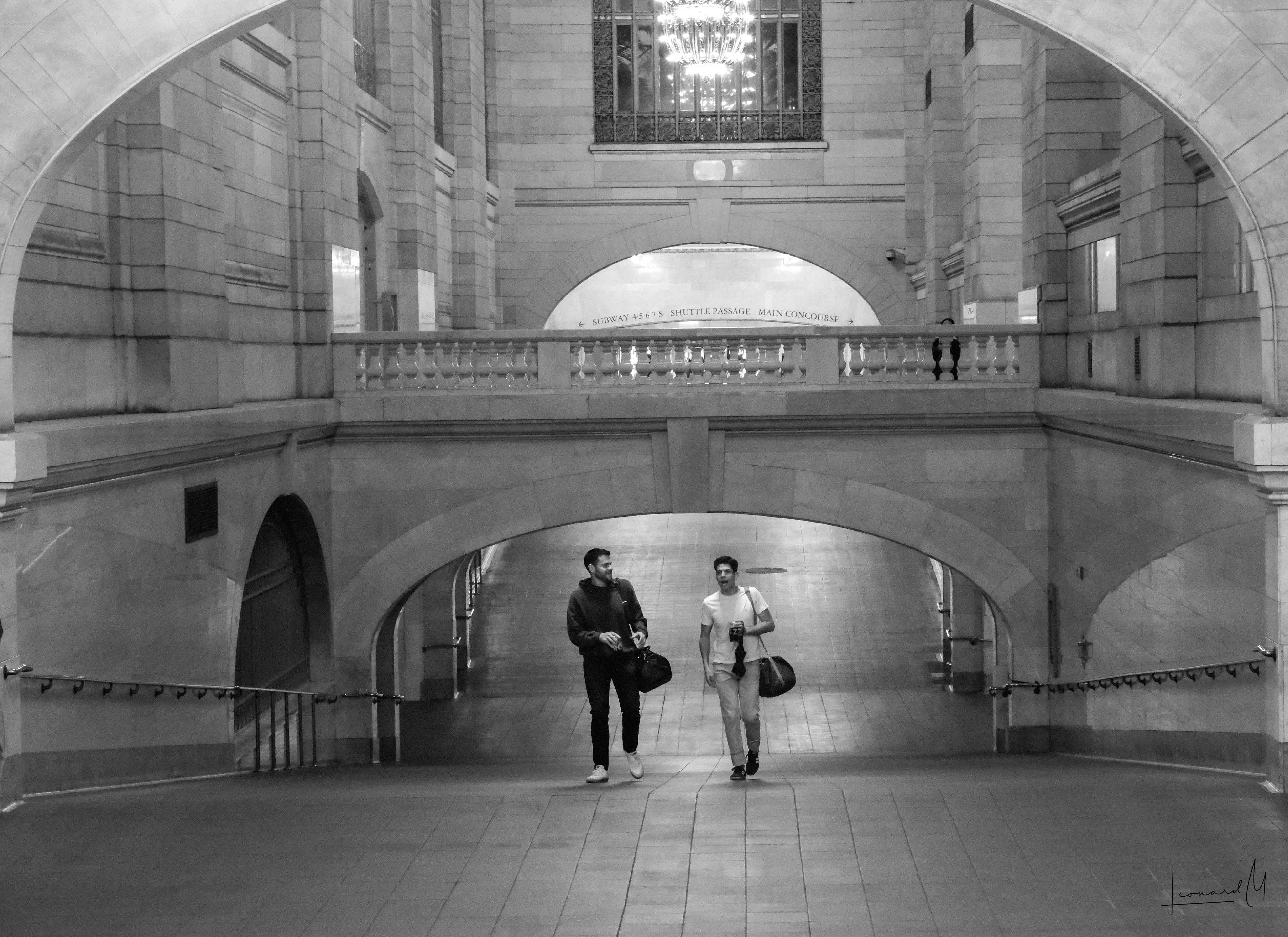 Two people sharing a quiet conversation in the morning rush.