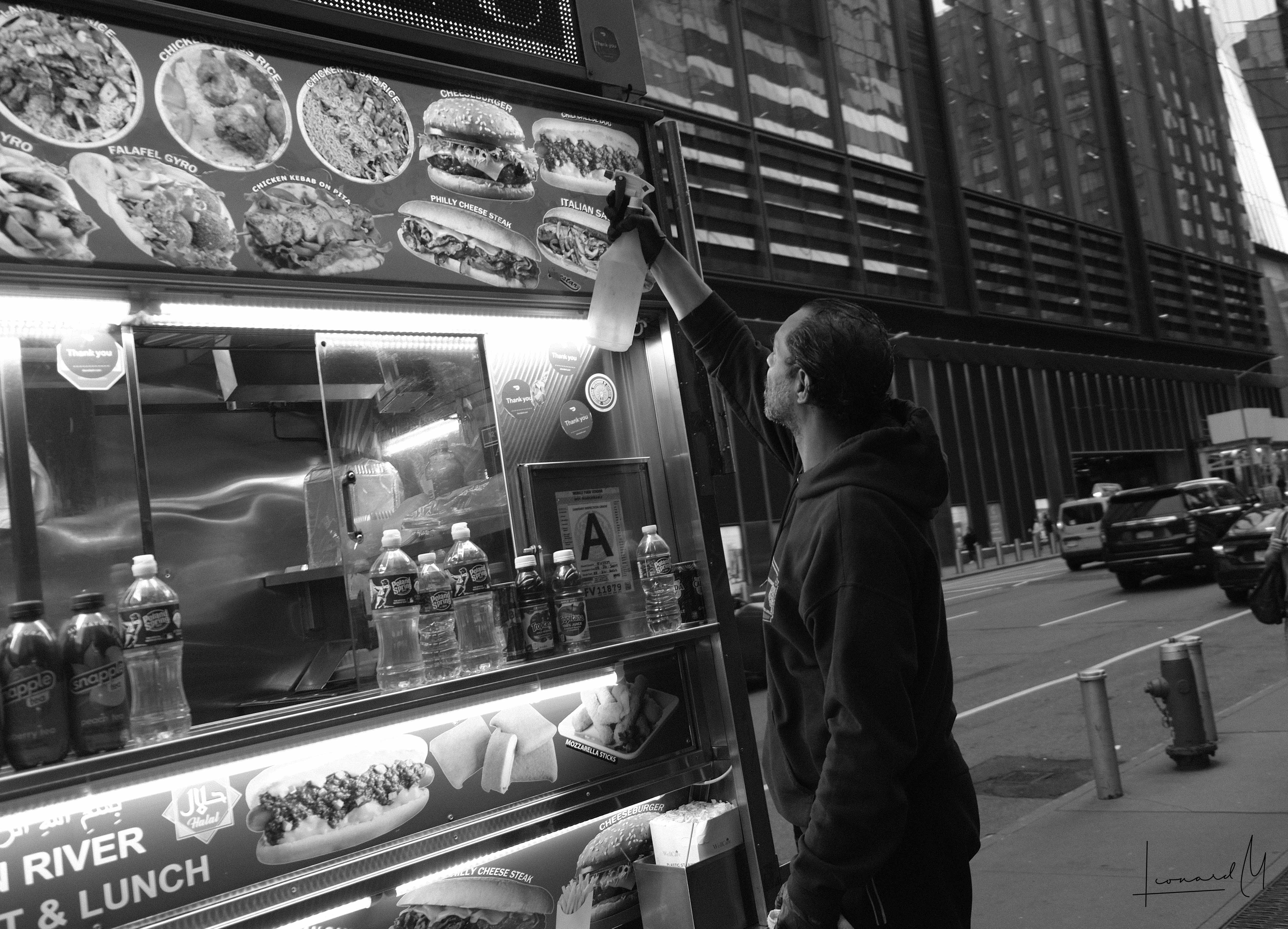 A man cleaning his Halal Cart