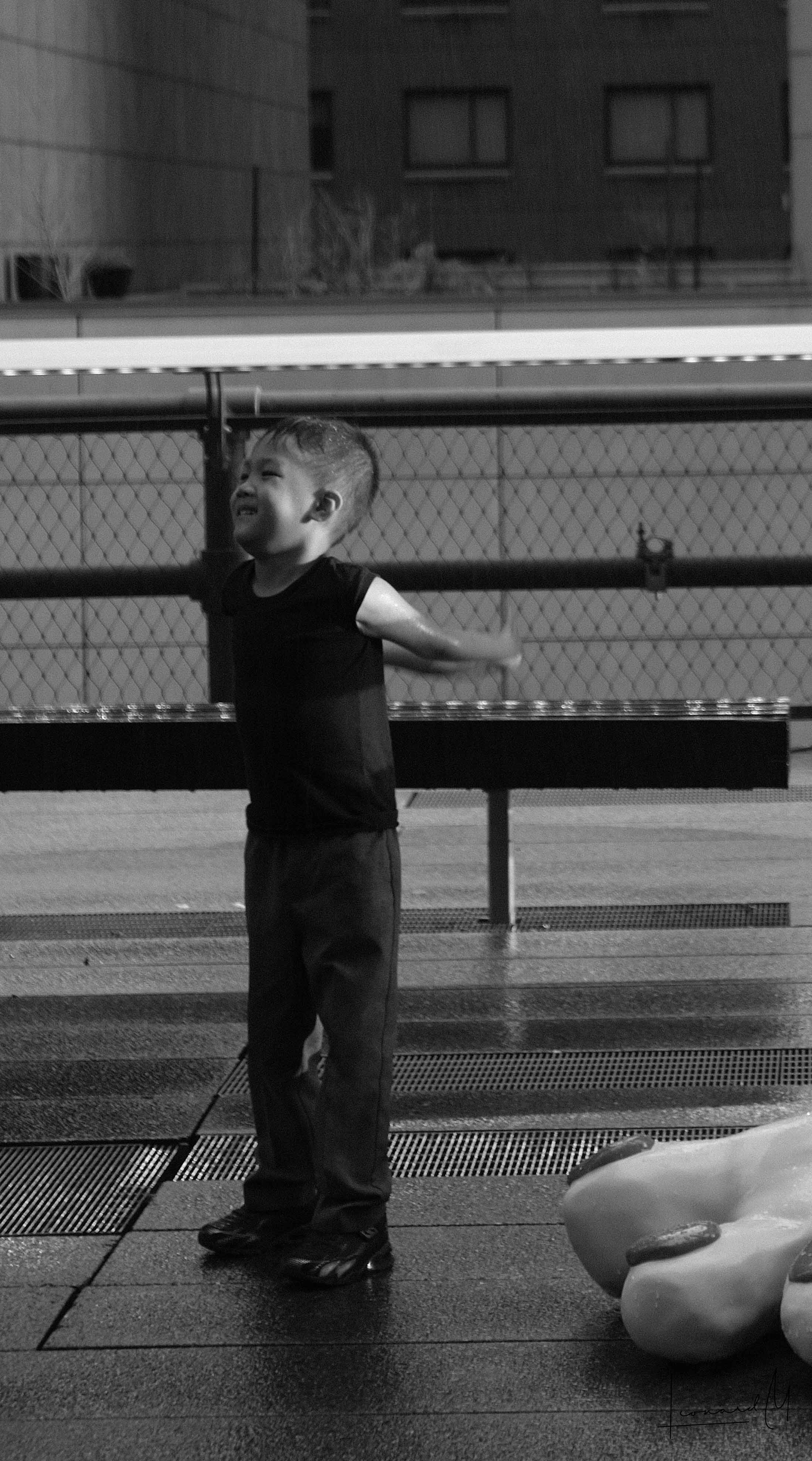 A child having fun with the toes of a statue in the frame
